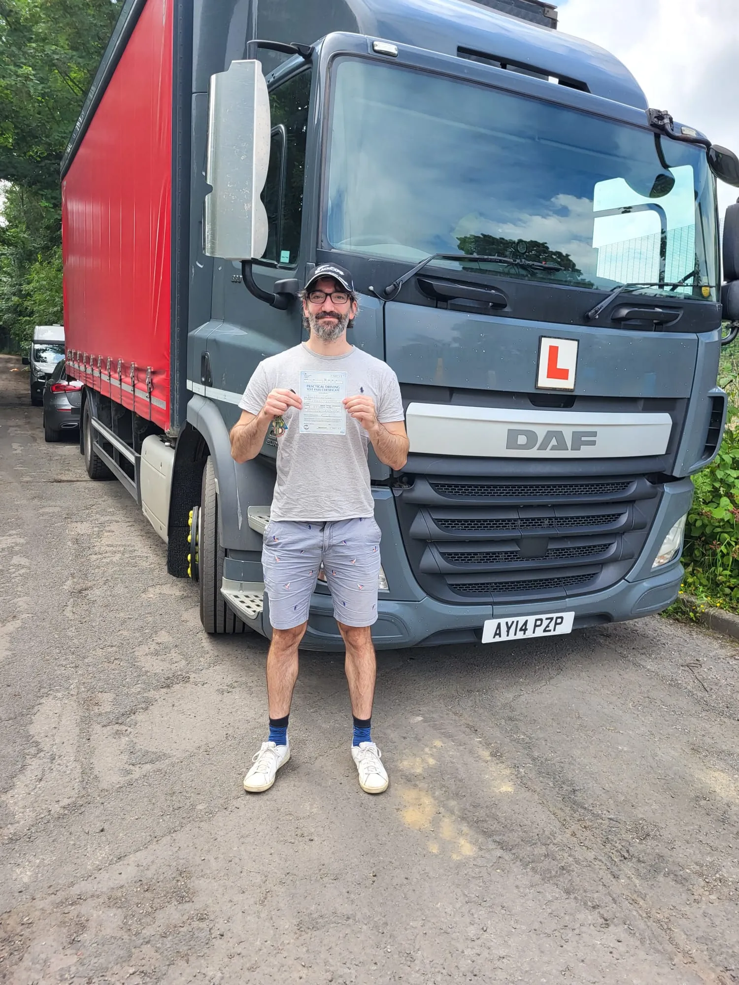 A man standing in front of a large truck.