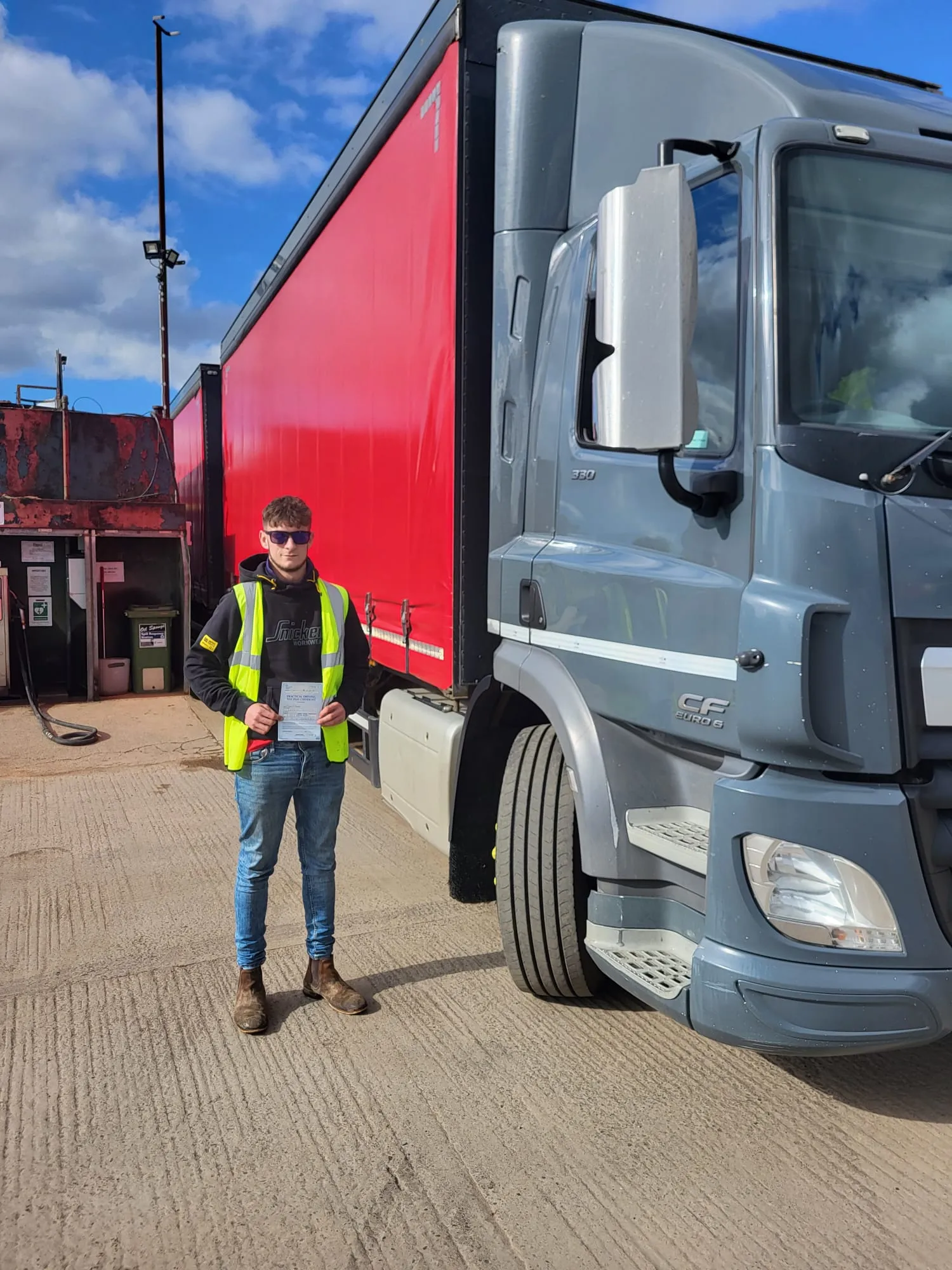 A man standing next to a semi truck.