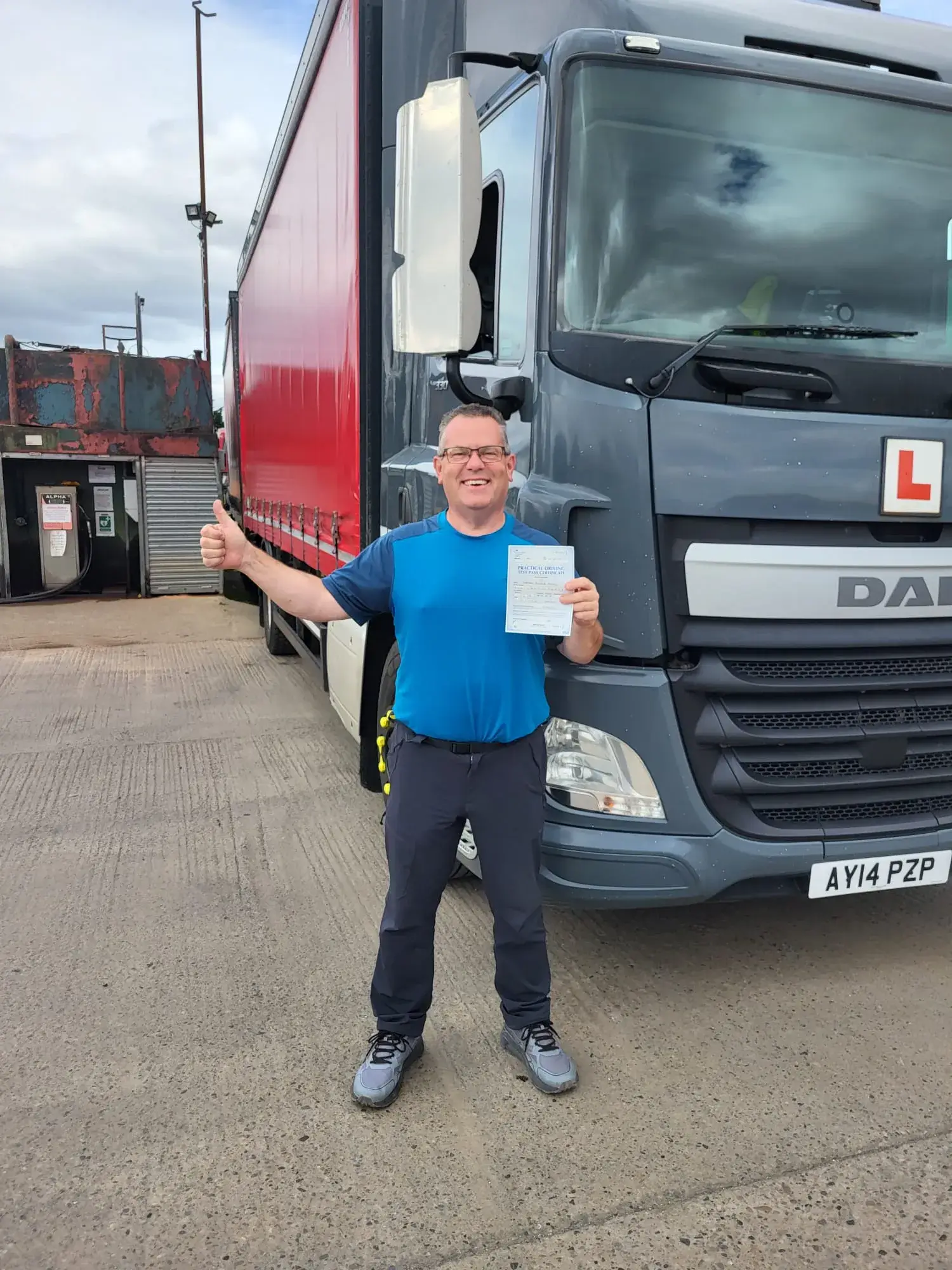 A man standing in front of a large truck.